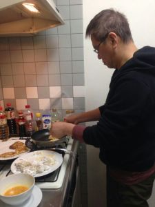 apprentice chef at work frying white radish cake